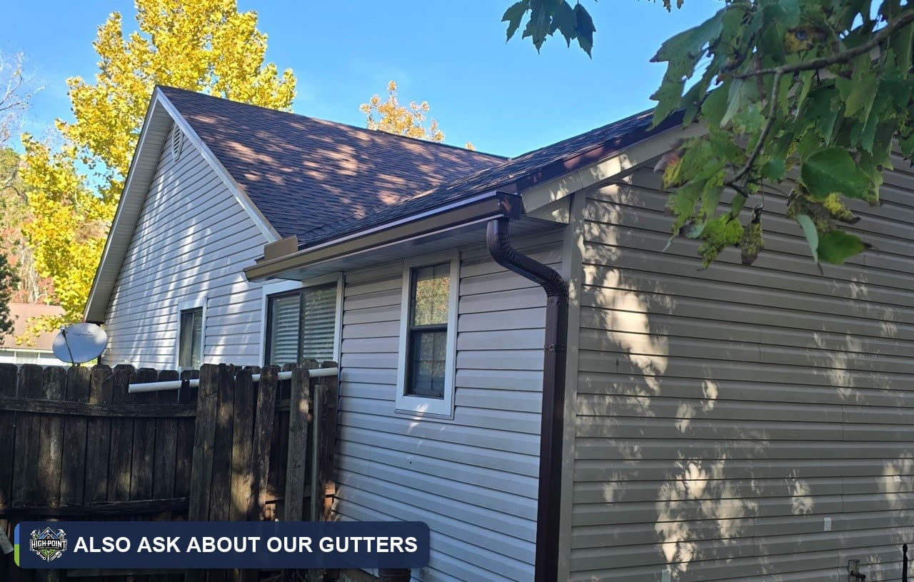Gutter and downspout on the side of a sided home