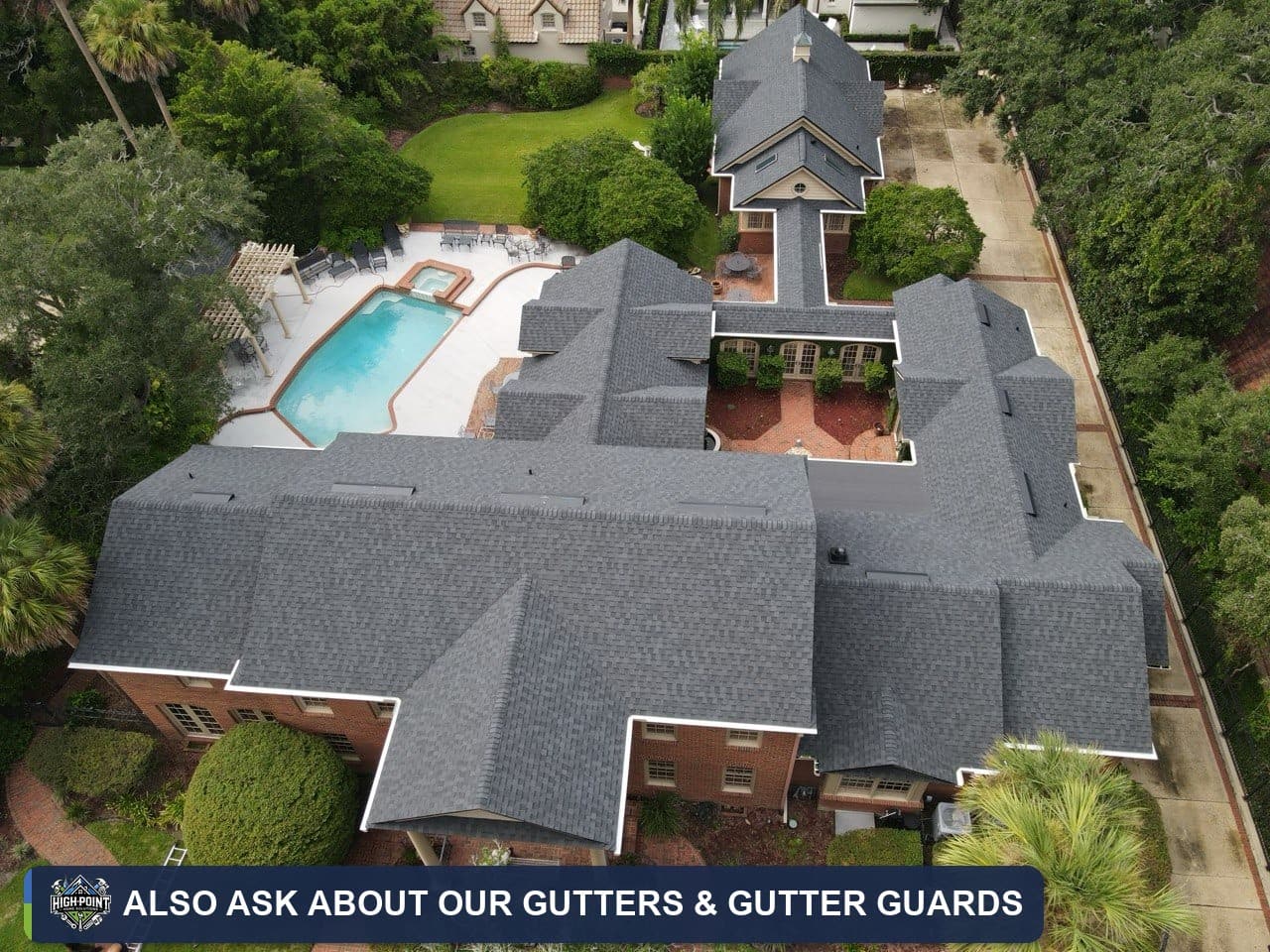 Aerial view of a shingle roof with gutters and gutter guards