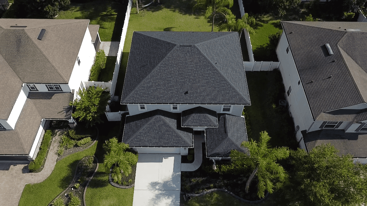 Aerial view of a Florida home with a completed roof and gutter lines