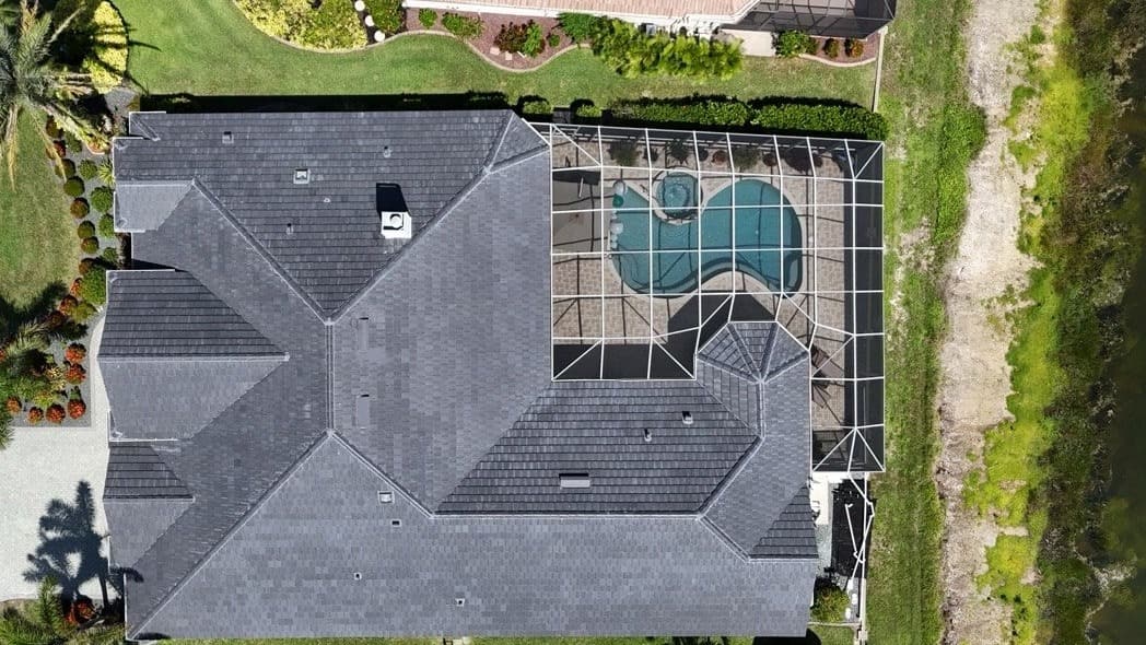 Overhead view of a shingle roof beside a screened pool