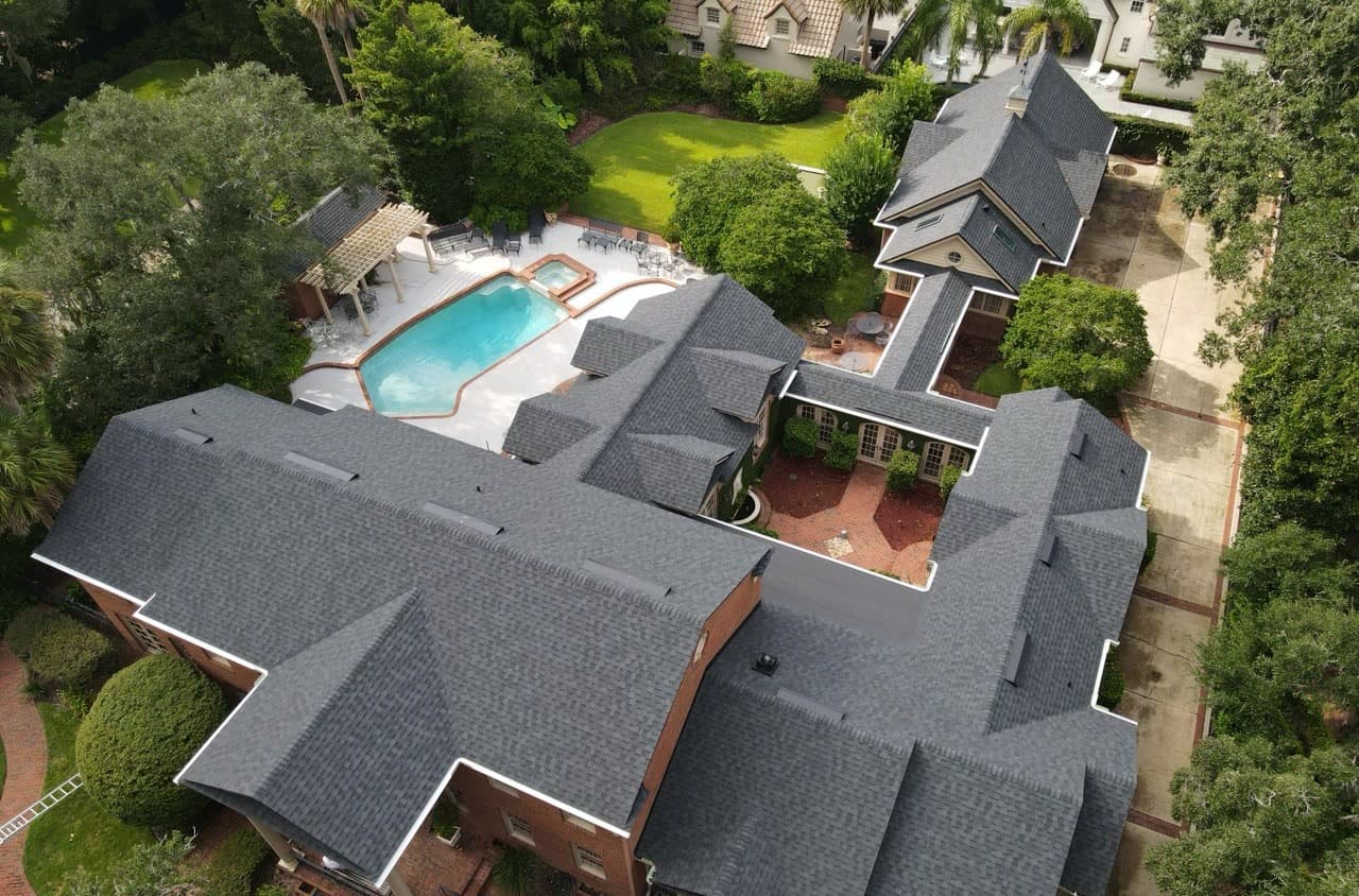 Aerial view of a gray shingle roof and courtyard